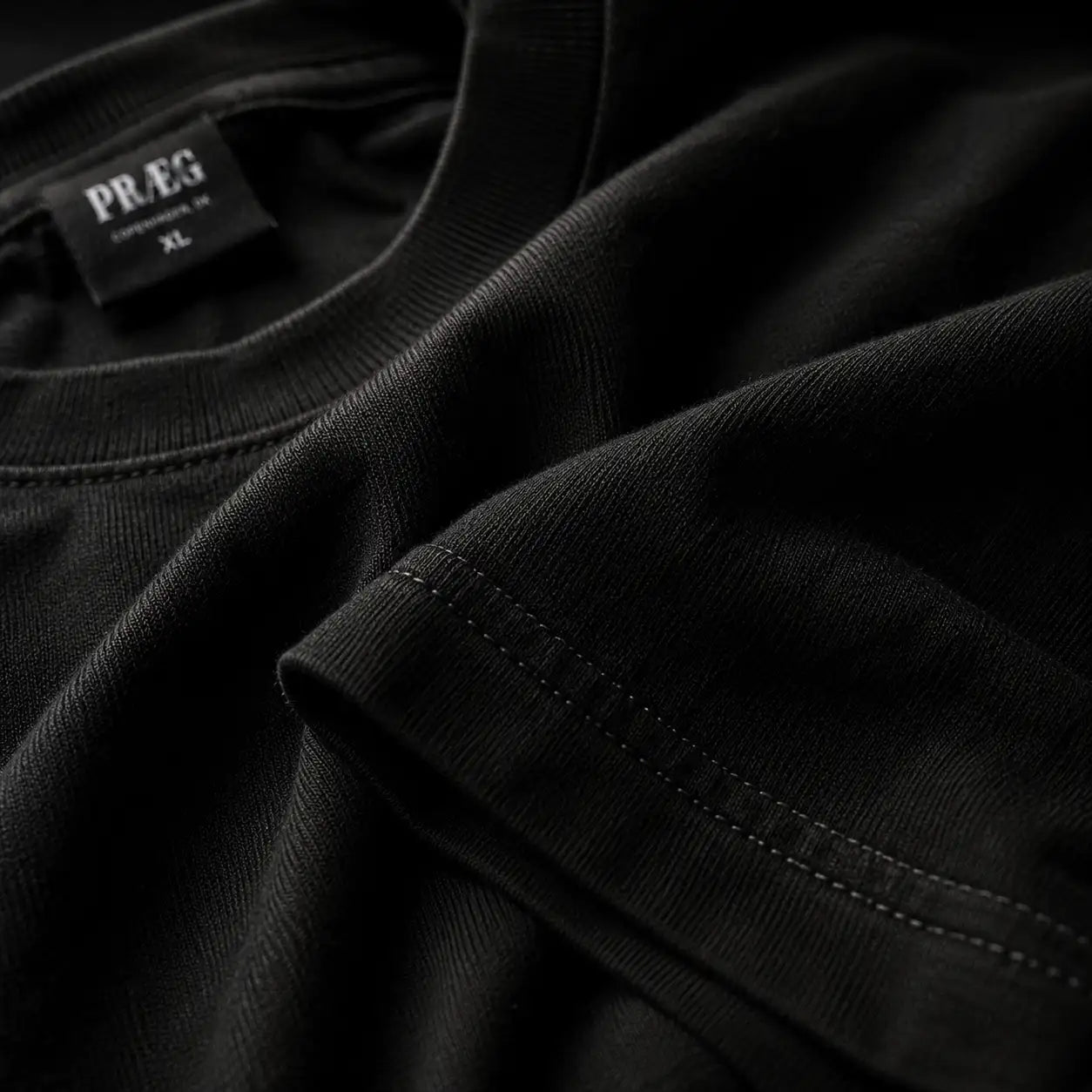 Macro close-up of PRÆG black heavyweight cotton fabric